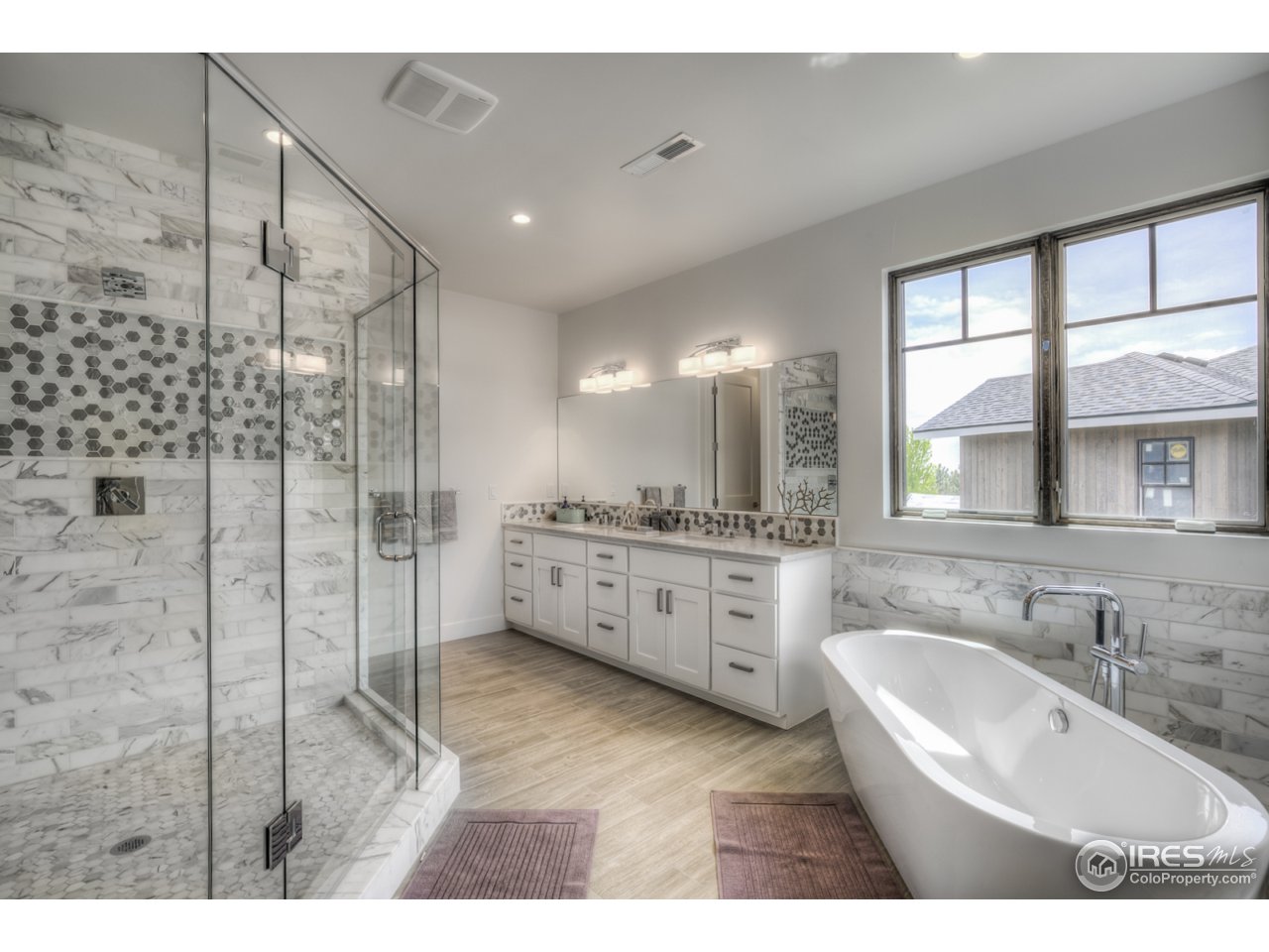 4845 6th Street Boulder, CO 80304 - Photo 14 of 25 a bathroom with a double vanity sink a toilet a mirror and shower