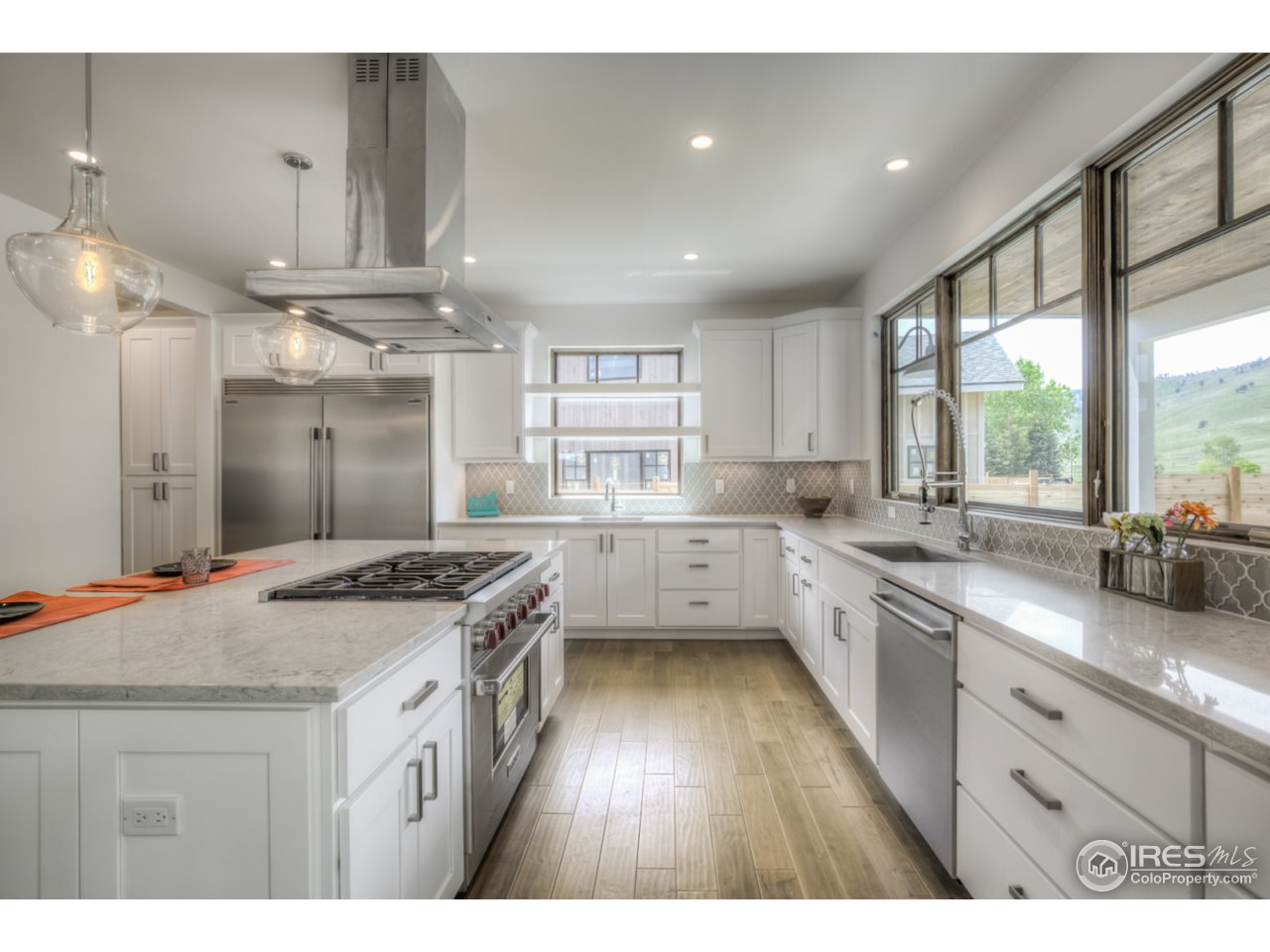 4845 6th Street Boulder, CO 80304 - Photo 7 of 25 a kitchen with a stove a sink a refrigerator and wooden floor