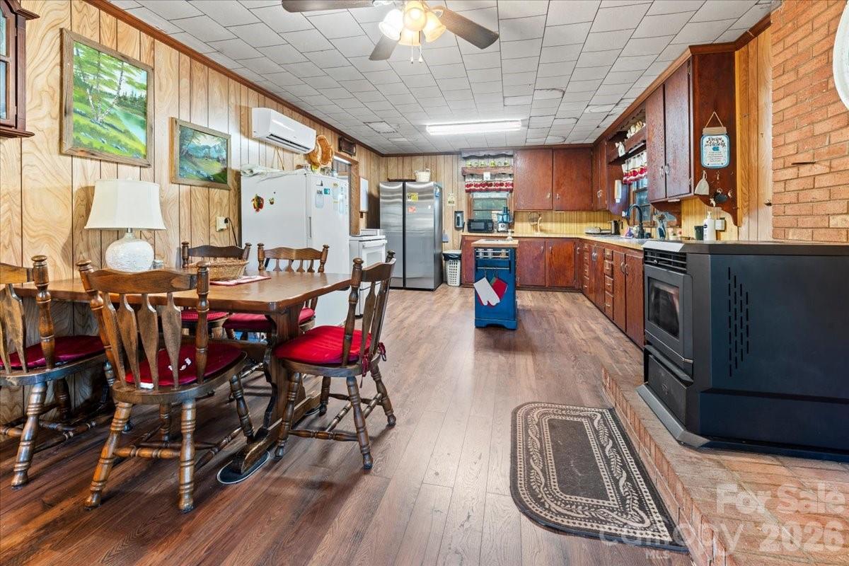 12282 Coyle Road Stanfield, NC 28163 - Photo 7 of 24 a view of a dining room with furniture one side kitchen view and wooden floor