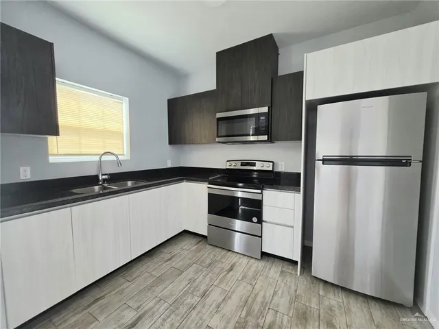 a kitchen with a refrigerator and a sink