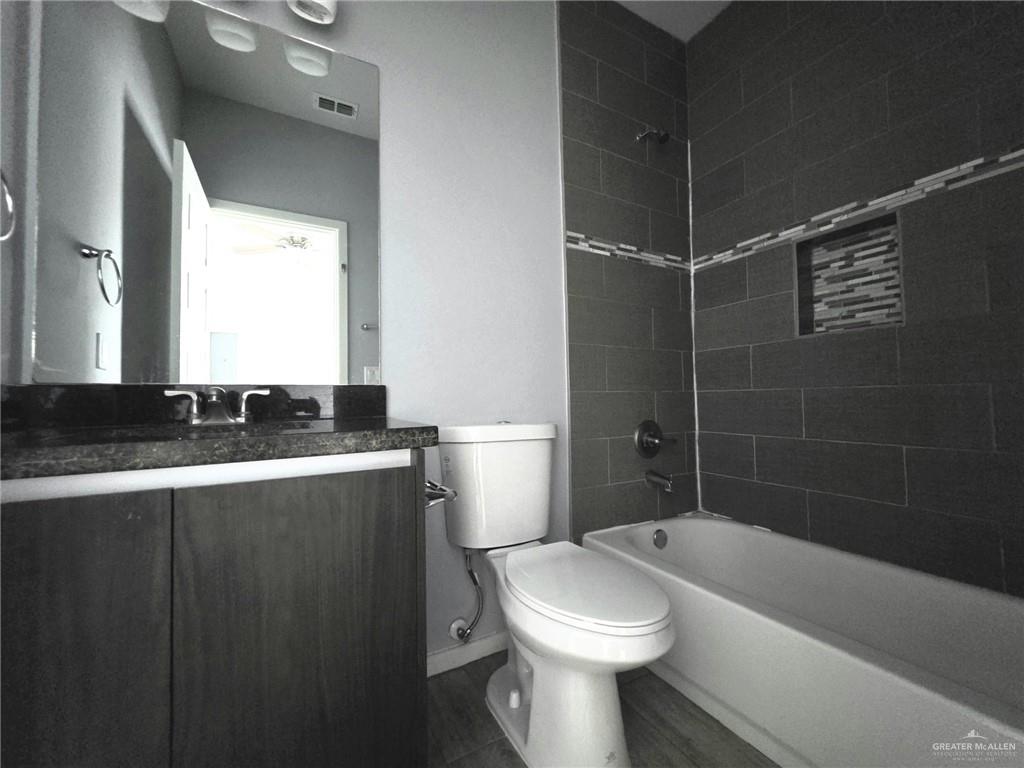 1514 Quitaca Drive, Unit 3 Edinburg, TX 78541 - Photo 5 of 10 a bathroom with a sink a toilet and shower