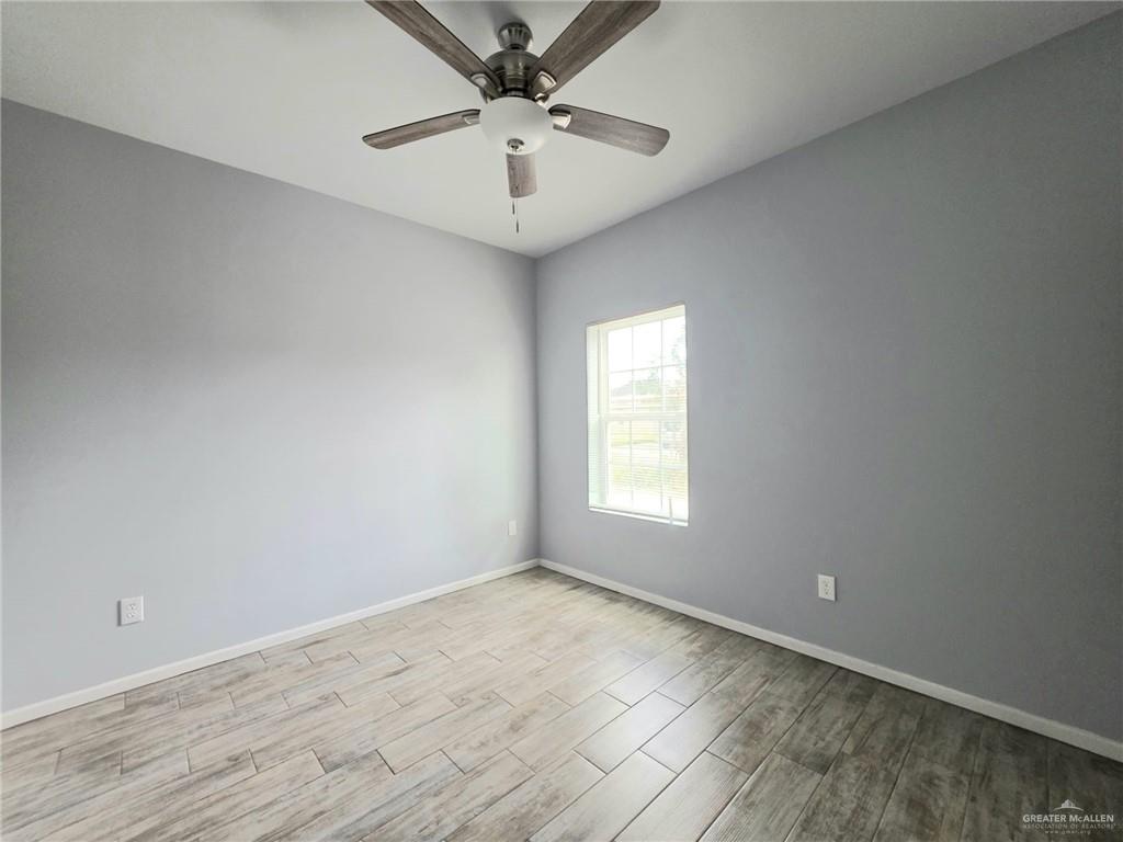1514 Quitaca Drive, Unit 3 Edinburg, TX 78541 - Photo 6 of 10 an empty room with a window and a fan