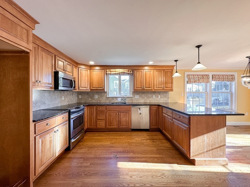 29 Douglas Road Needham, MA 02492 - Photo 2 of 42 a kitchen with stainless steel appliances granite countertop a stove a sink dishwasher and a refrigerator