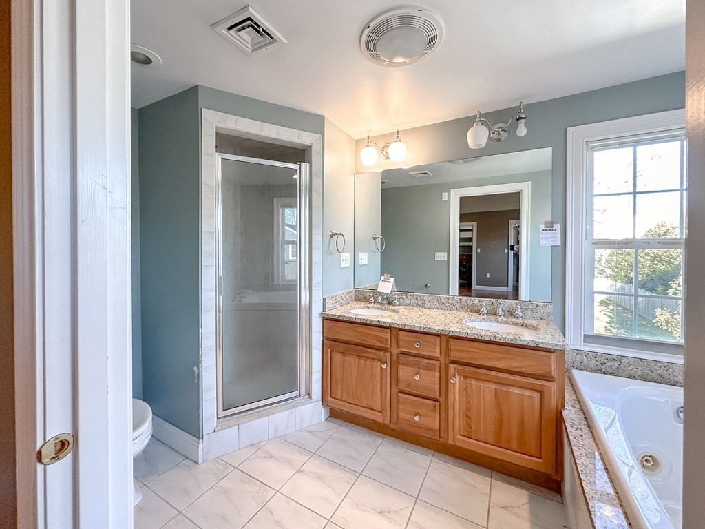 29 Douglas Road Needham, MA 02492 - Photo 22 of 42 a spacious bathroom with a granite countertop sink mirror and a bathtub