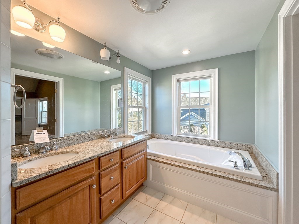 29 Douglas Road Needham, MA 02492 - Photo 23 of 42 a spacious bathroom with a granite countertop tub sink and mirror