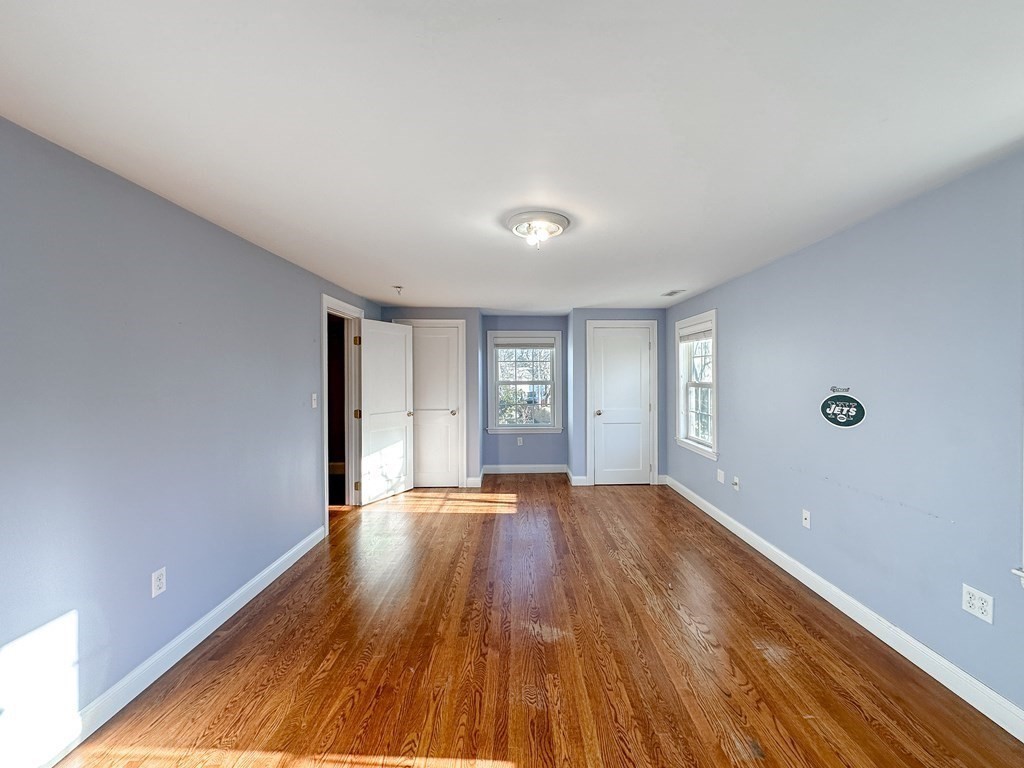 29 Douglas Road Needham, MA 02492 - Photo 25 of 42 a view of an empty room with wooden floor and window