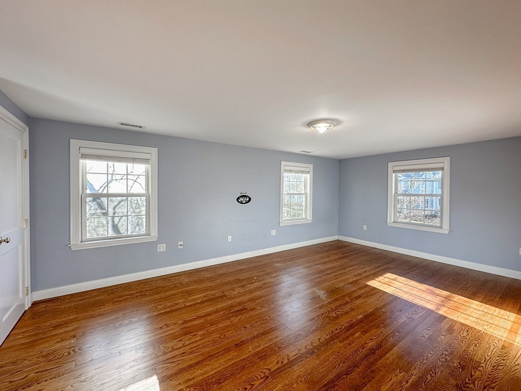 29 Douglas Road Needham, MA 02492 - Photo 26 of 42 a view of an empty room with wooden floor and a window
