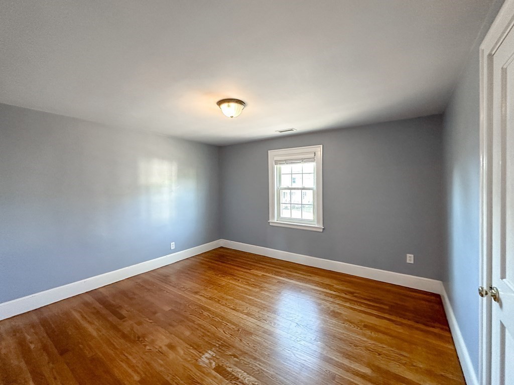 29 Douglas Road Needham, MA 02492 - Photo 27 of 42 an empty room with wooden floor and windows