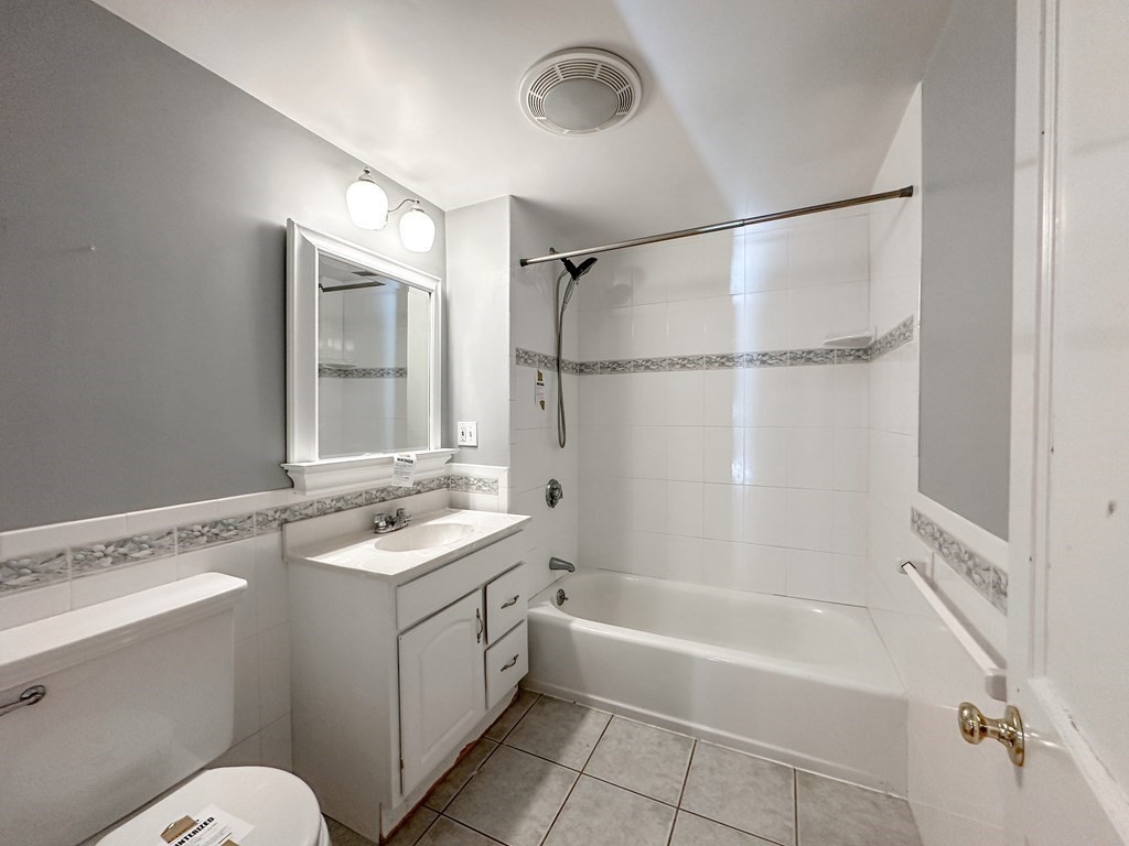 29 Douglas Road Needham, MA 02492 - Photo 29 of 42 a bathroom with a granite countertop sink mirror toilet and bathtub