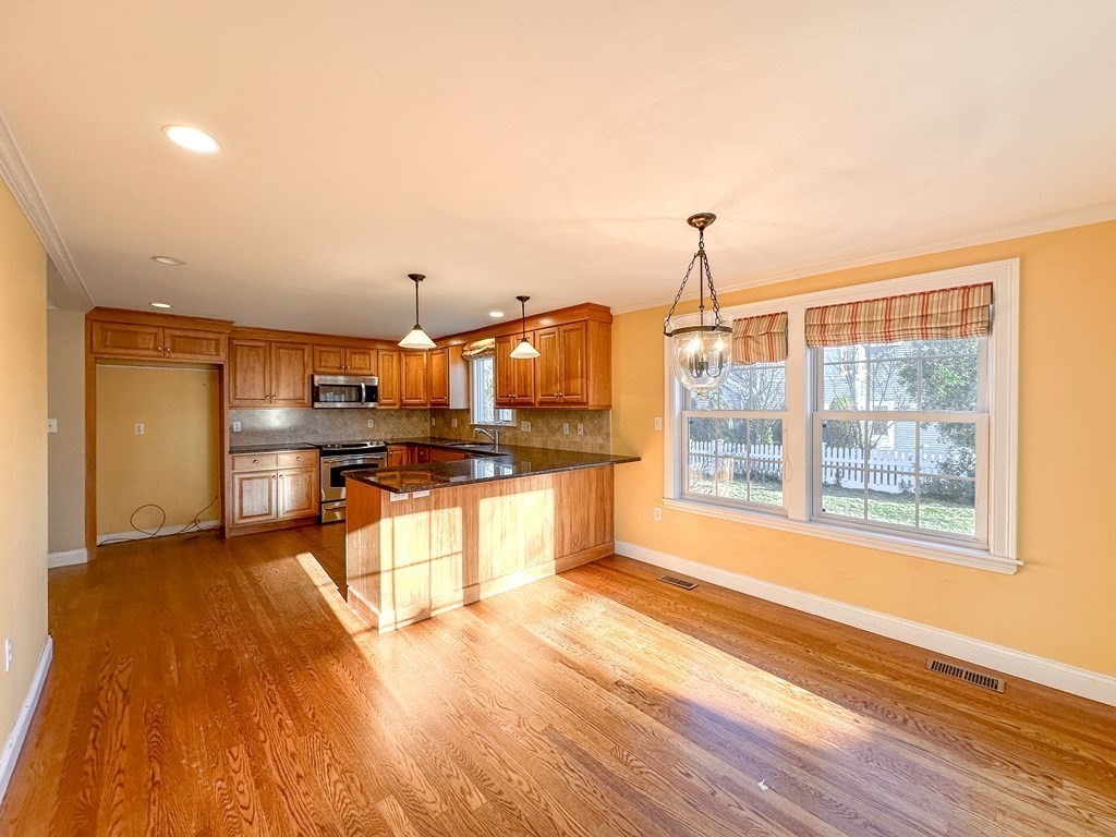 29 Douglas Road Needham, MA 02492 - Photo 6 of 42 a open kitchen with granite countertop a sink cabinets and wooden floor