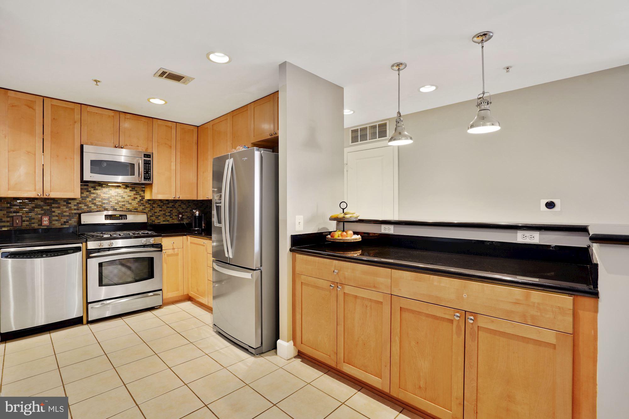 3600 South Glebe Road, Unit 632W Arlington, VA 22202 - Photo 5 of 41 a kitchen with granite countertop a refrigerator and a sink
