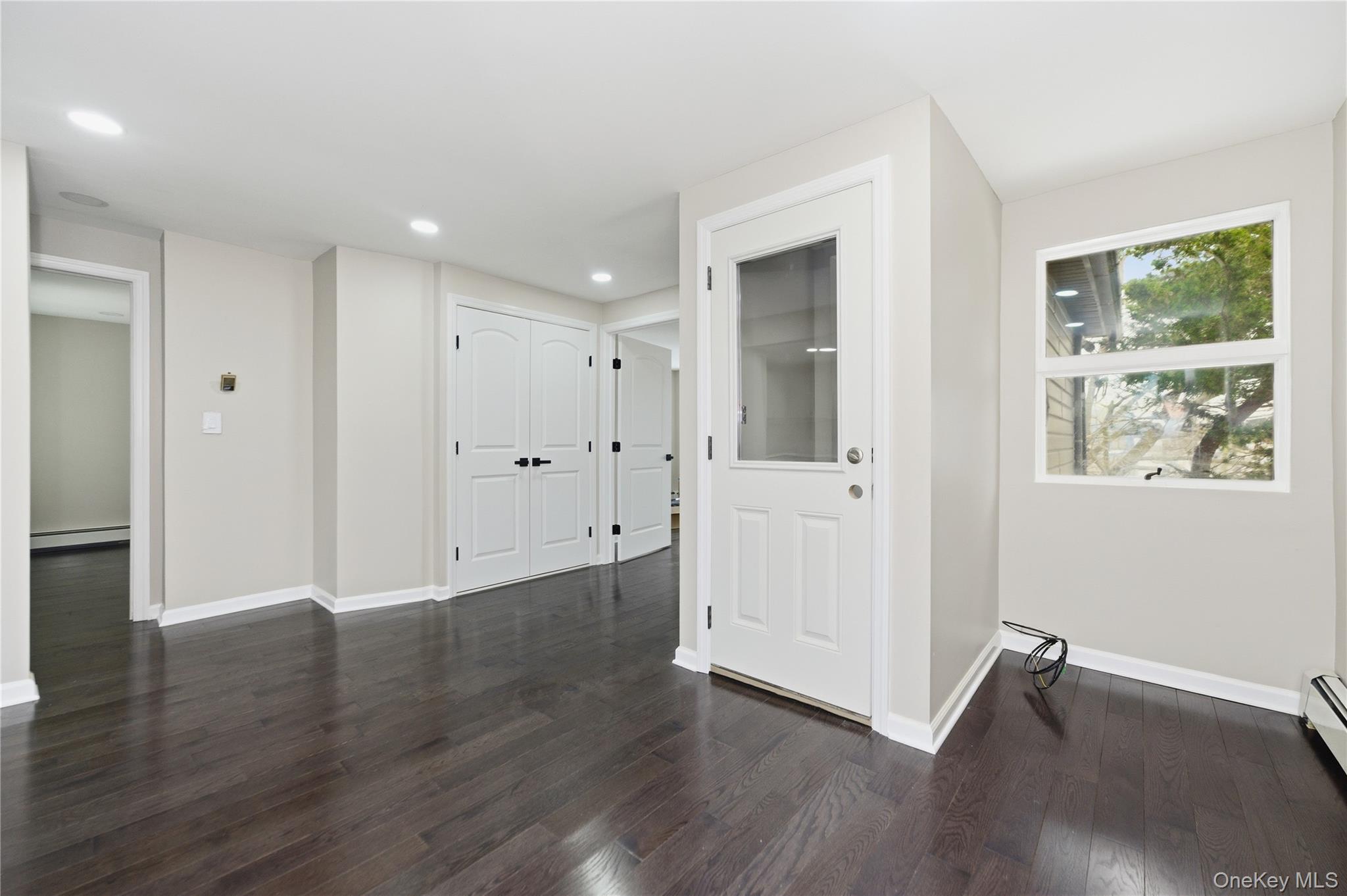 120 Maple Avenue, Unit 2 Cedarhurst, NY 11516 - Photo 1 of 17 a view of an empty room with wooden floor and window