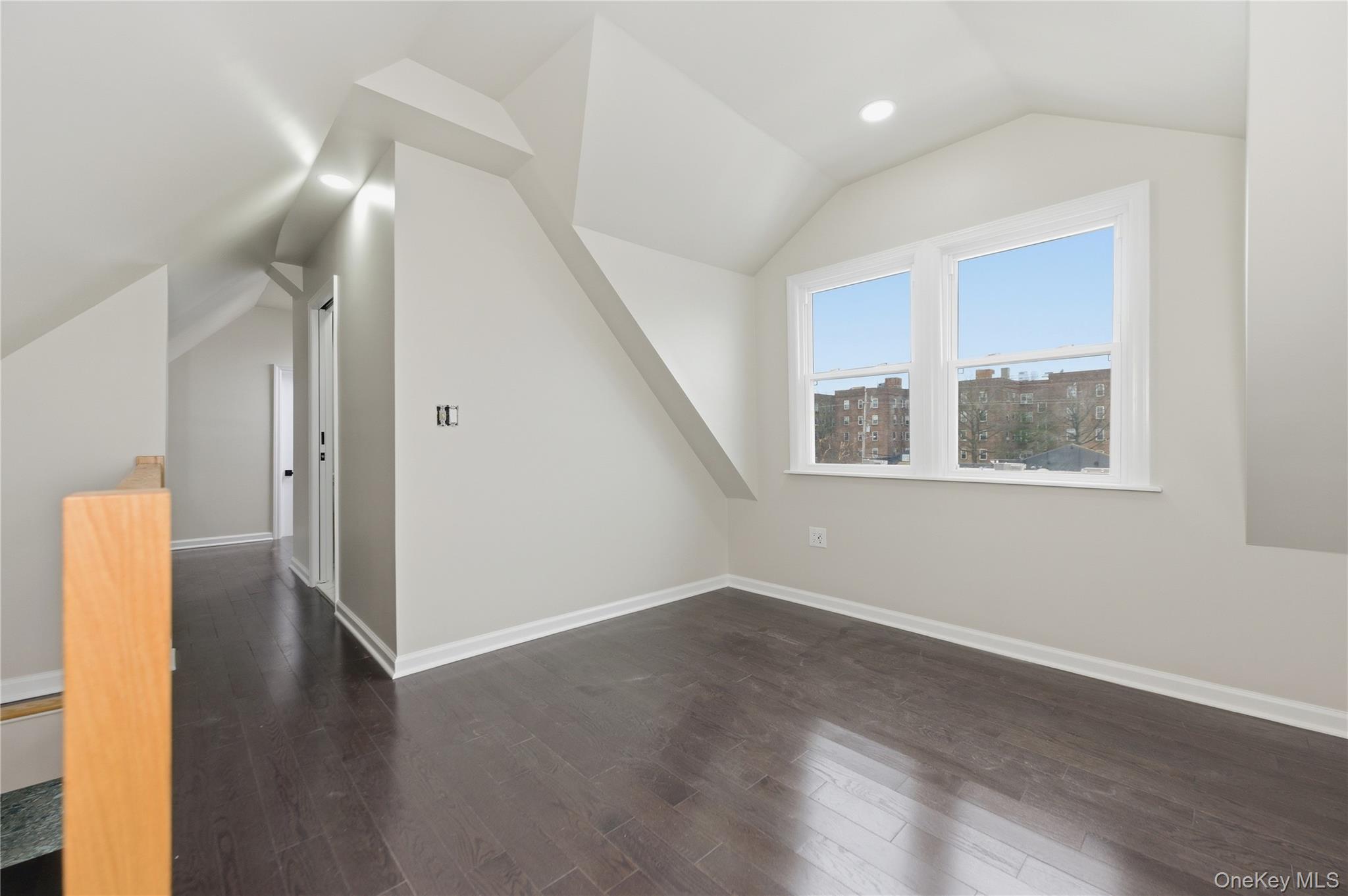 120 Maple Avenue, Unit 2 Cedarhurst, NY 11516 - Photo 13 of 17 an empty room with wooden floor and windows