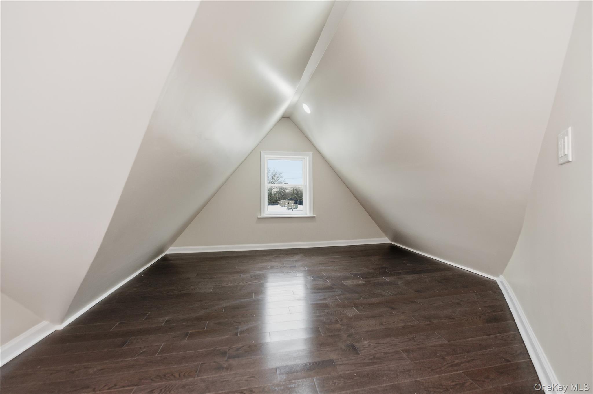 120 Maple Avenue, Unit 2 Cedarhurst, NY 11516 - Photo 14 of 17 an empty room with wooden floor and windows