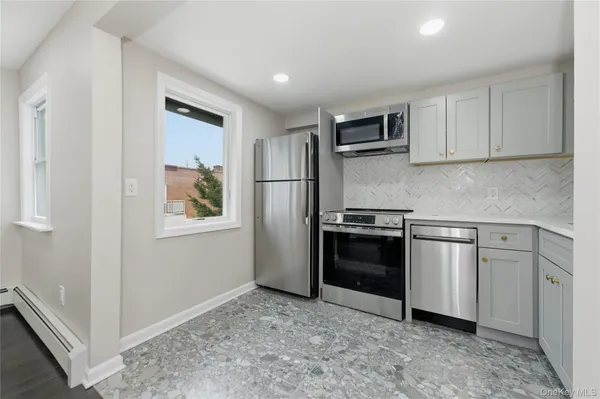 a kitchen with stainless steel appliances granite countertop a refrigerator and a stove top oven