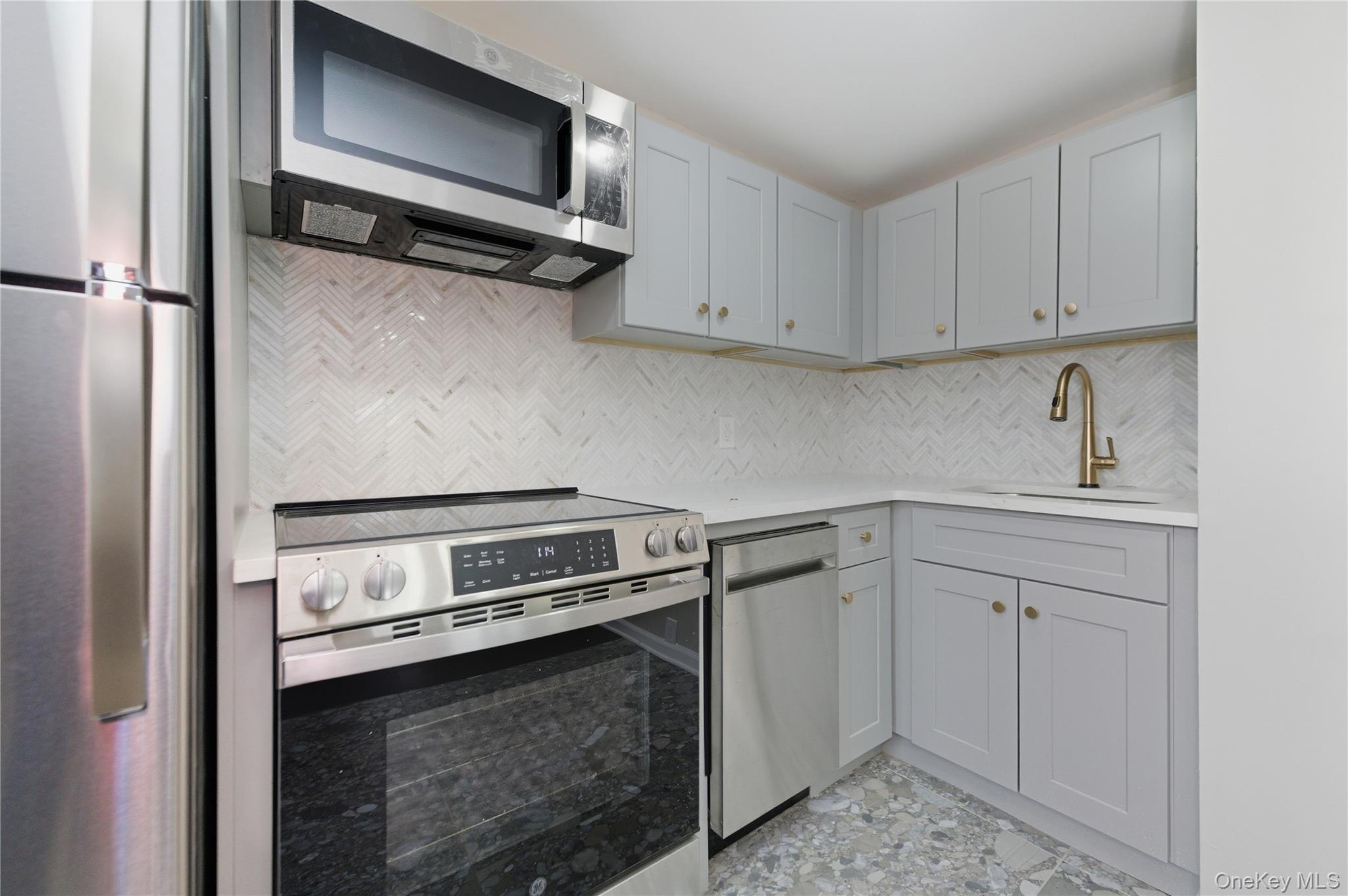 120 Maple Avenue, Unit 2 Cedarhurst, NY 11516 - Photo 6 of 17 a kitchen with a sink and cabinets