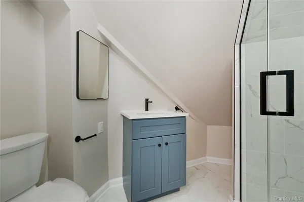 a bathroom with a toilet sink and mirror