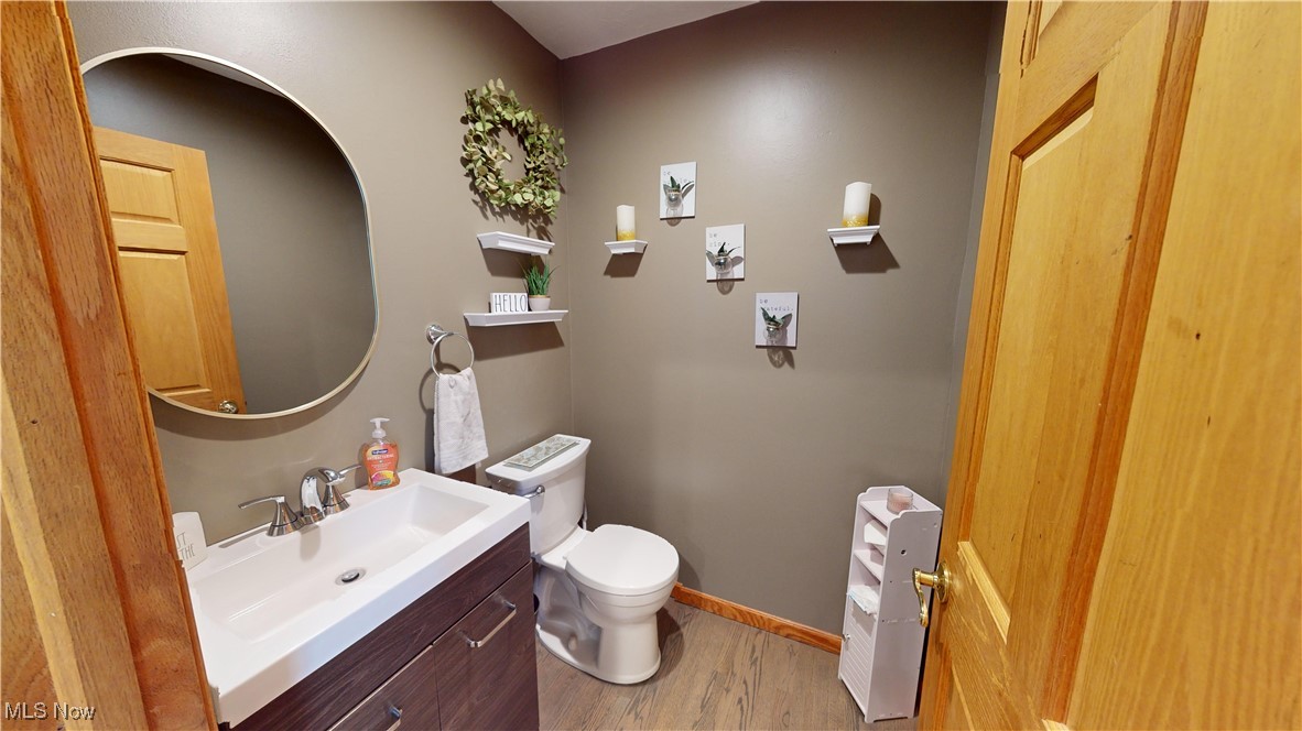 571 Ledge Road Macedonia, OH 44056 - Photo 13 of 35 Bathroom featuring vanity, toilet, and wood-type flooring