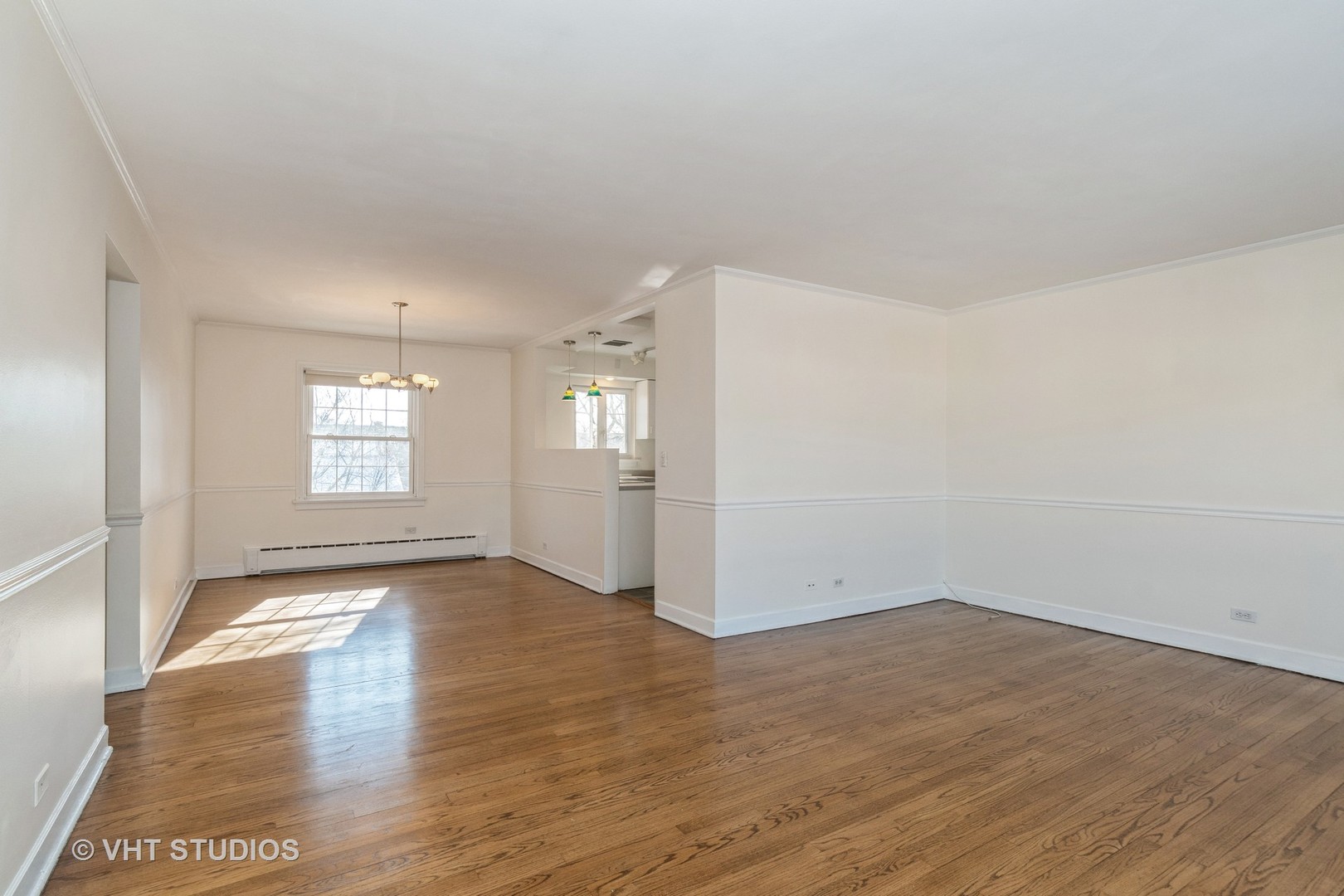 334 Ridge Avenue, Unit 3 Evanston, IL 60202 - Photo 9 of 12 an empty room with wooden floor and windows
