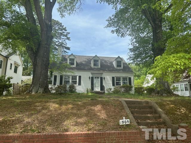 1309 Canterbury Road Raleigh, NC 27607 - Photo 2 of 32 a front view of a house with a garden