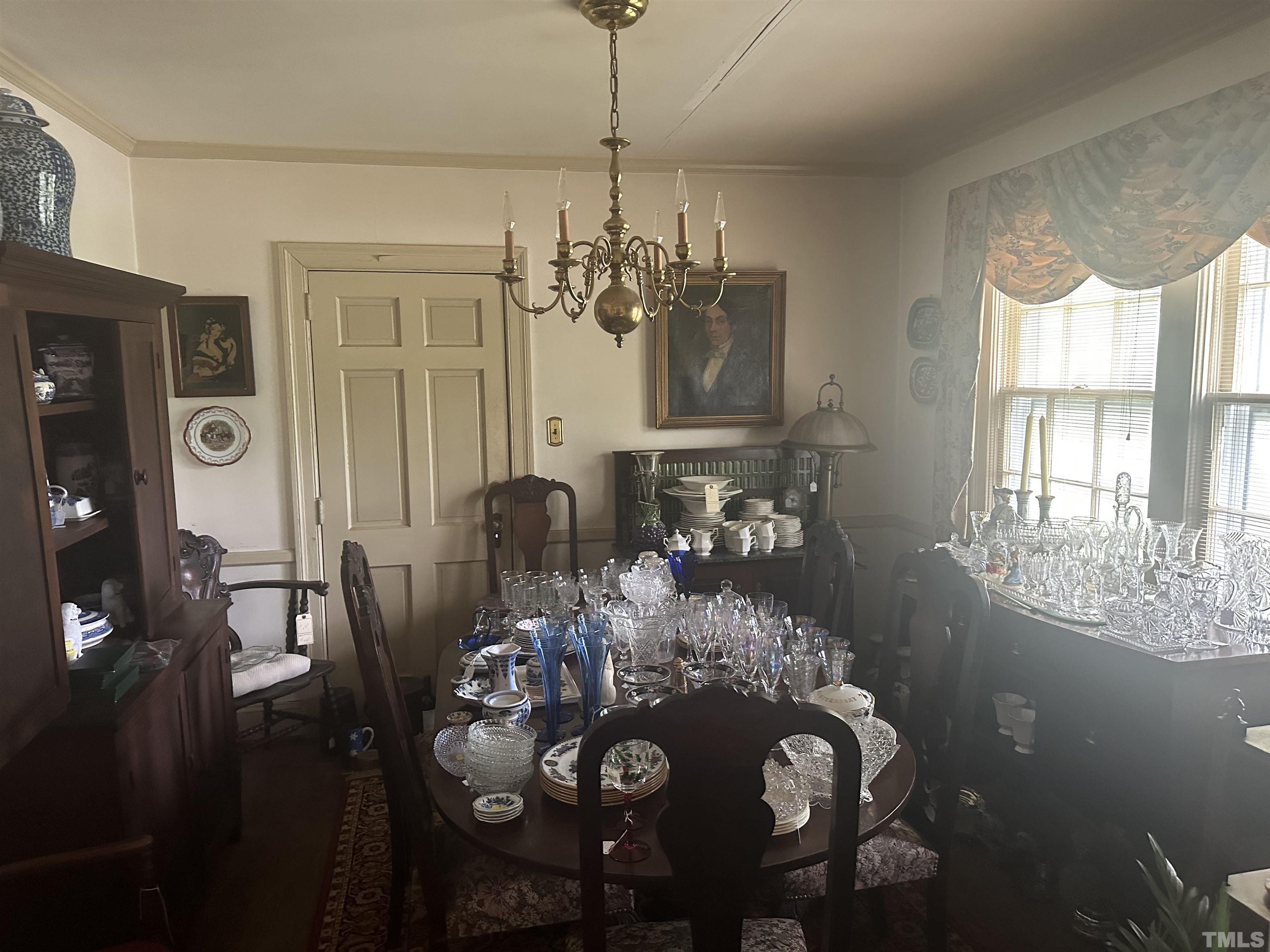 1309 Canterbury Road Raleigh, NC 27607 - Photo 4 of 32 a view of a dining room with furniture and chandelier