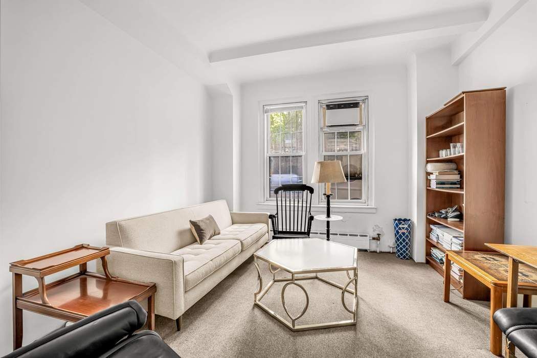 410 East 57th Street, Unit 1A Manhattan, NY 10022 - Photo 3 of 7 a living room with furniture cabinets and a window