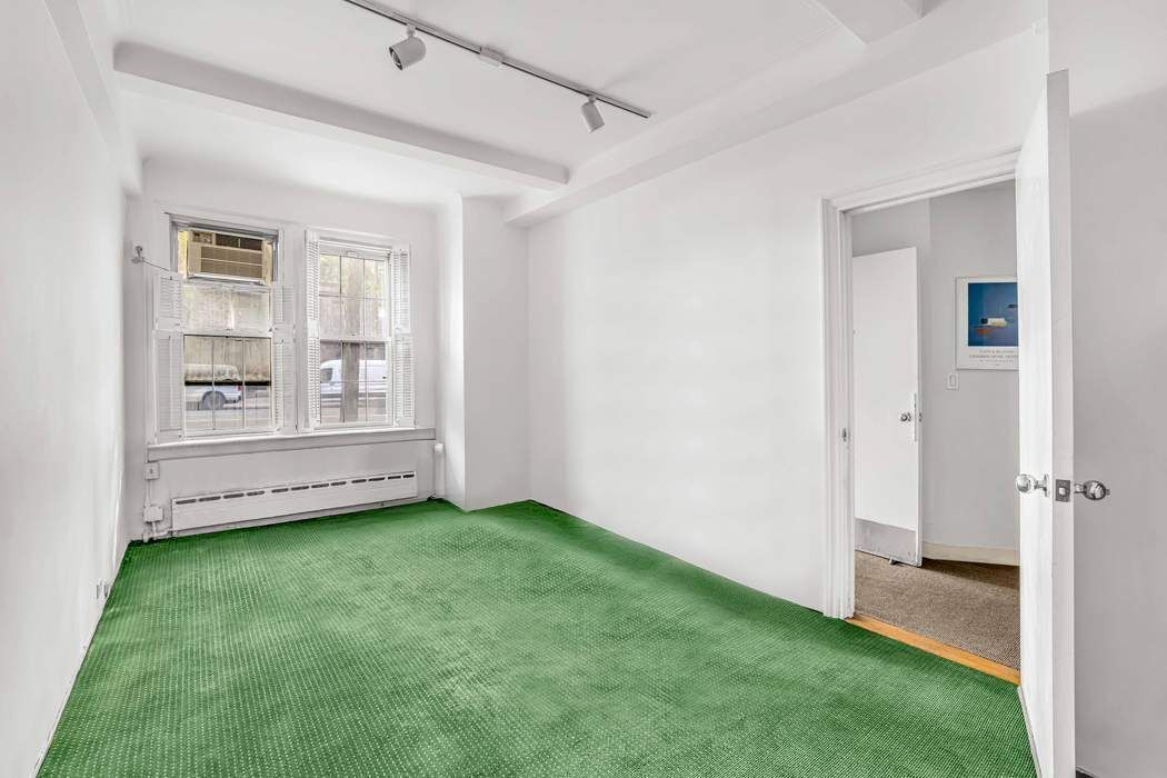 410 East 57th Street, Unit 1A Manhattan, NY 10022 - Photo 4 of 7 a view of an empty room with a window and closet