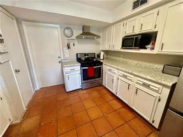 a bedroom with a bed and a television