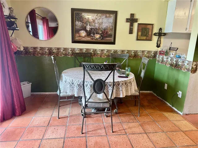 a bedroom with a bed and a refrigerator