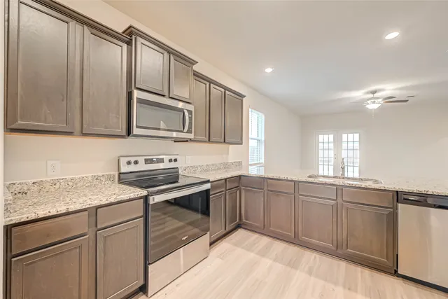 a bathroom with a granite countertop sink a mirror and window