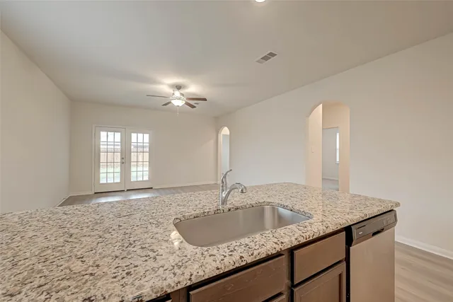 an empty room with wooden floor and a window