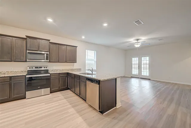a bathroom with a sink toilet vanity and shower