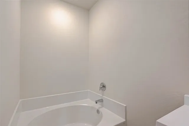 a white bath tub sitting next to a shower