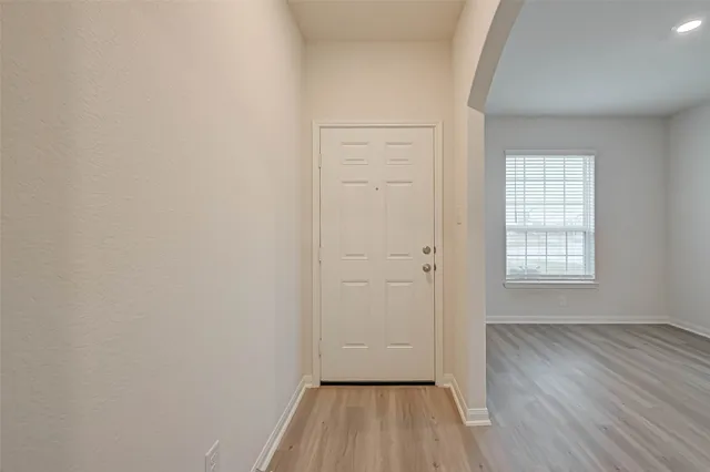 a view of a room with wooden floor closet and windows