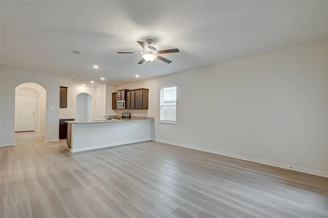 a kitchen with granite countertop a sink and white cabinets
