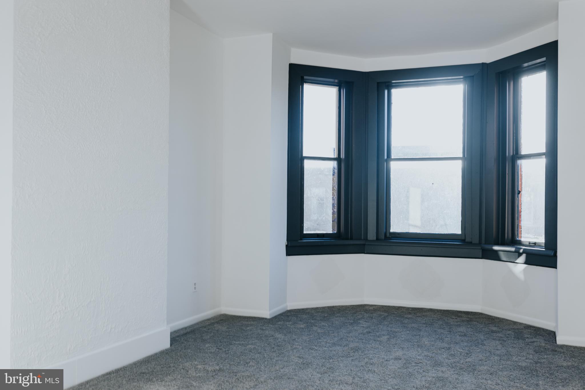 2511 Madison Avenue, Unit 3 Baltimore, MD 21217 - Photo 4 of 12 an empty room with windows