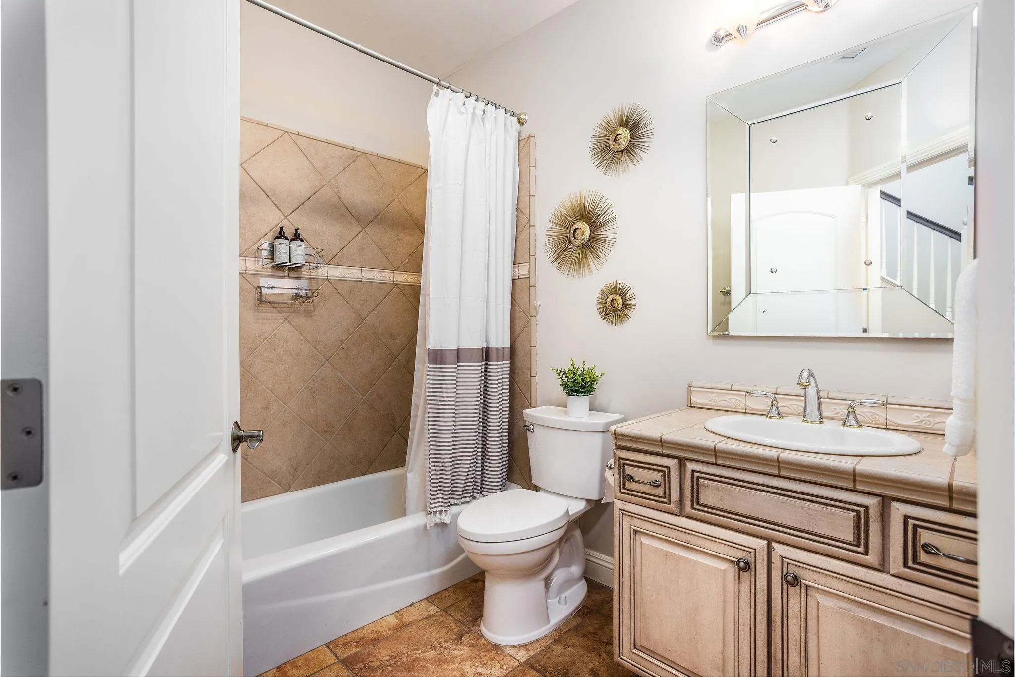 4003 Millagra Drive Fallbrook, CA 92028 - Photo 13 of 46 a bathroom with a granite countertop sink toilet a large mirror a bathtub and shower