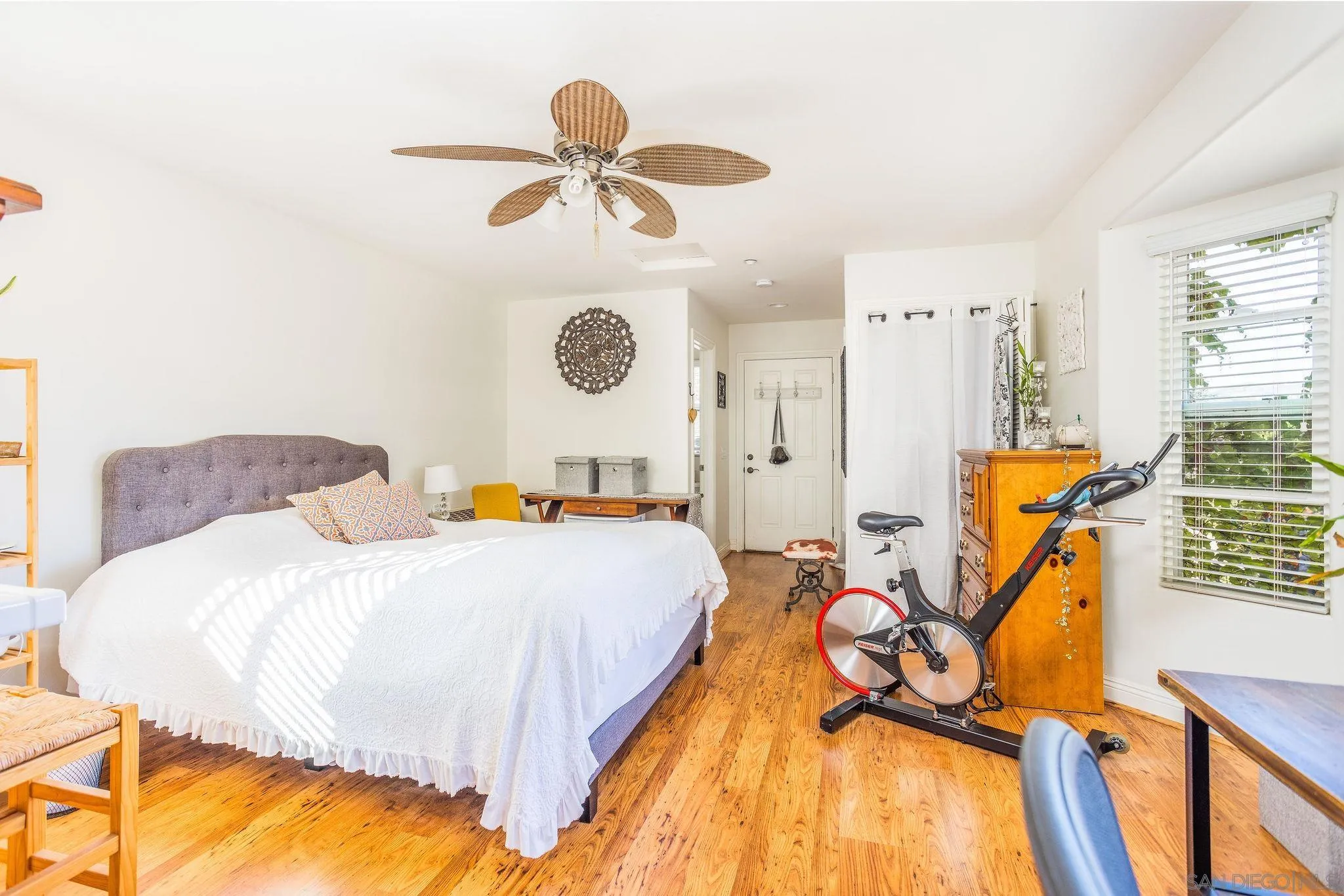 4003 Millagra Drive Fallbrook, CA 92028 - Photo 31 of 46 a bedroom with a bed chandelier and a window