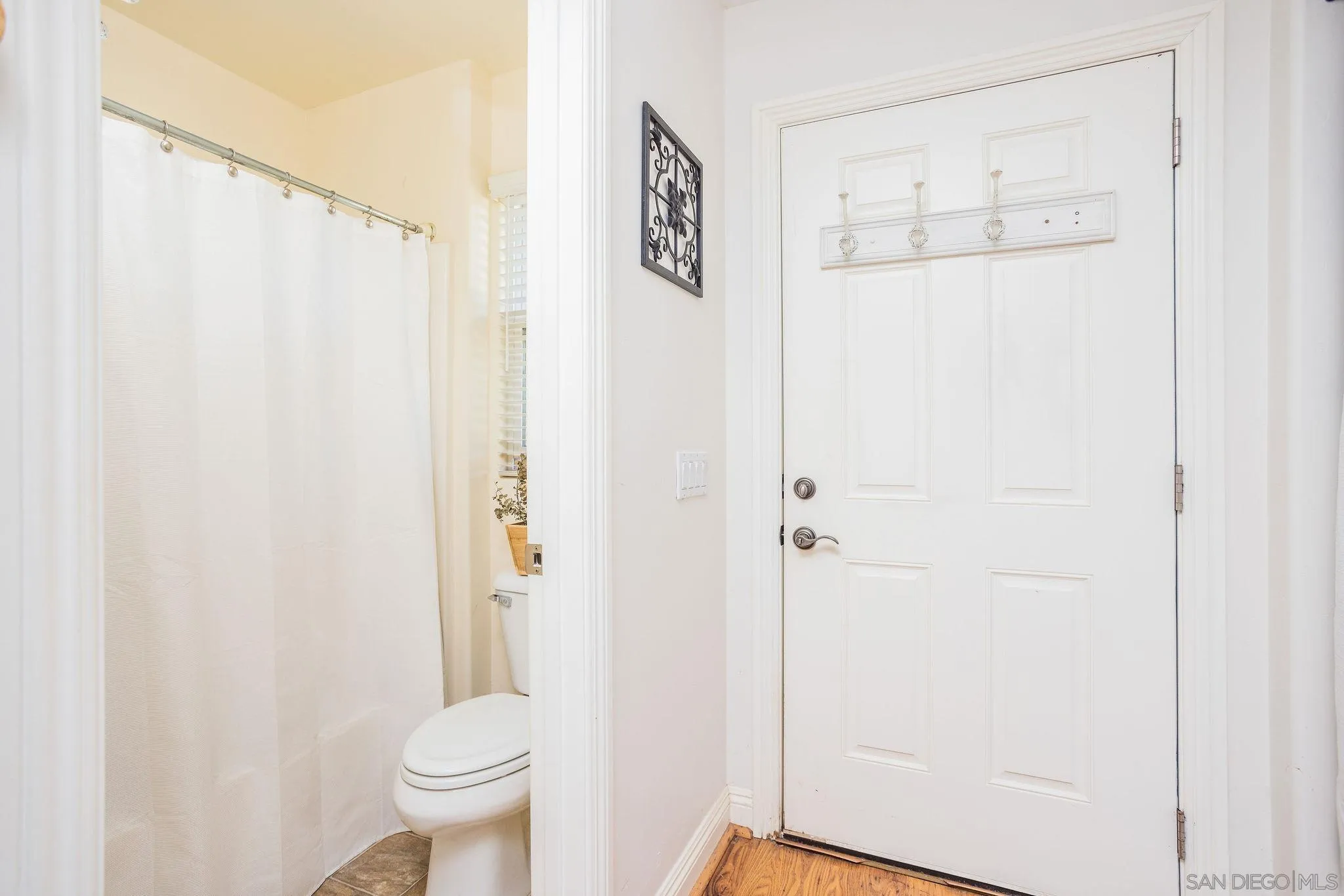 4003 Millagra Drive Fallbrook, CA 92028 - Photo 34 of 46 a bathroom with a shower curtain and a toilet