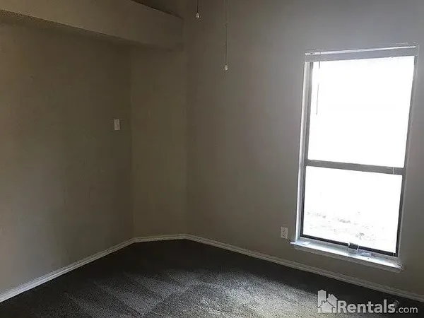 a view of wooden floor and windows in a room