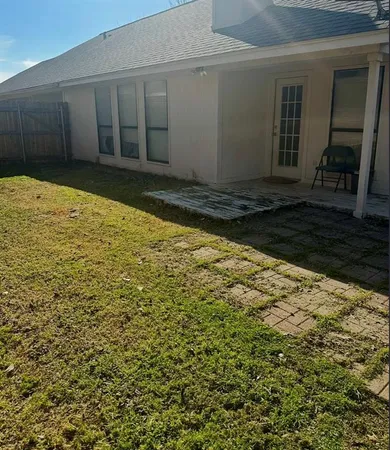 a view of a front door and small yard