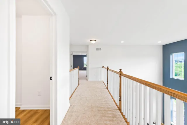 a front view of a house with garden and yard