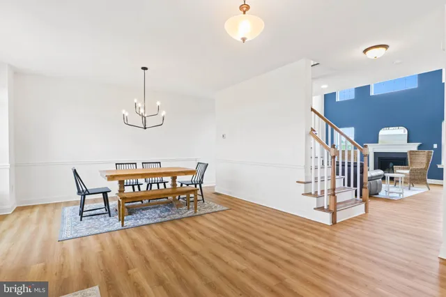 a view of a livingroom with furniture wooden floor and chandelier