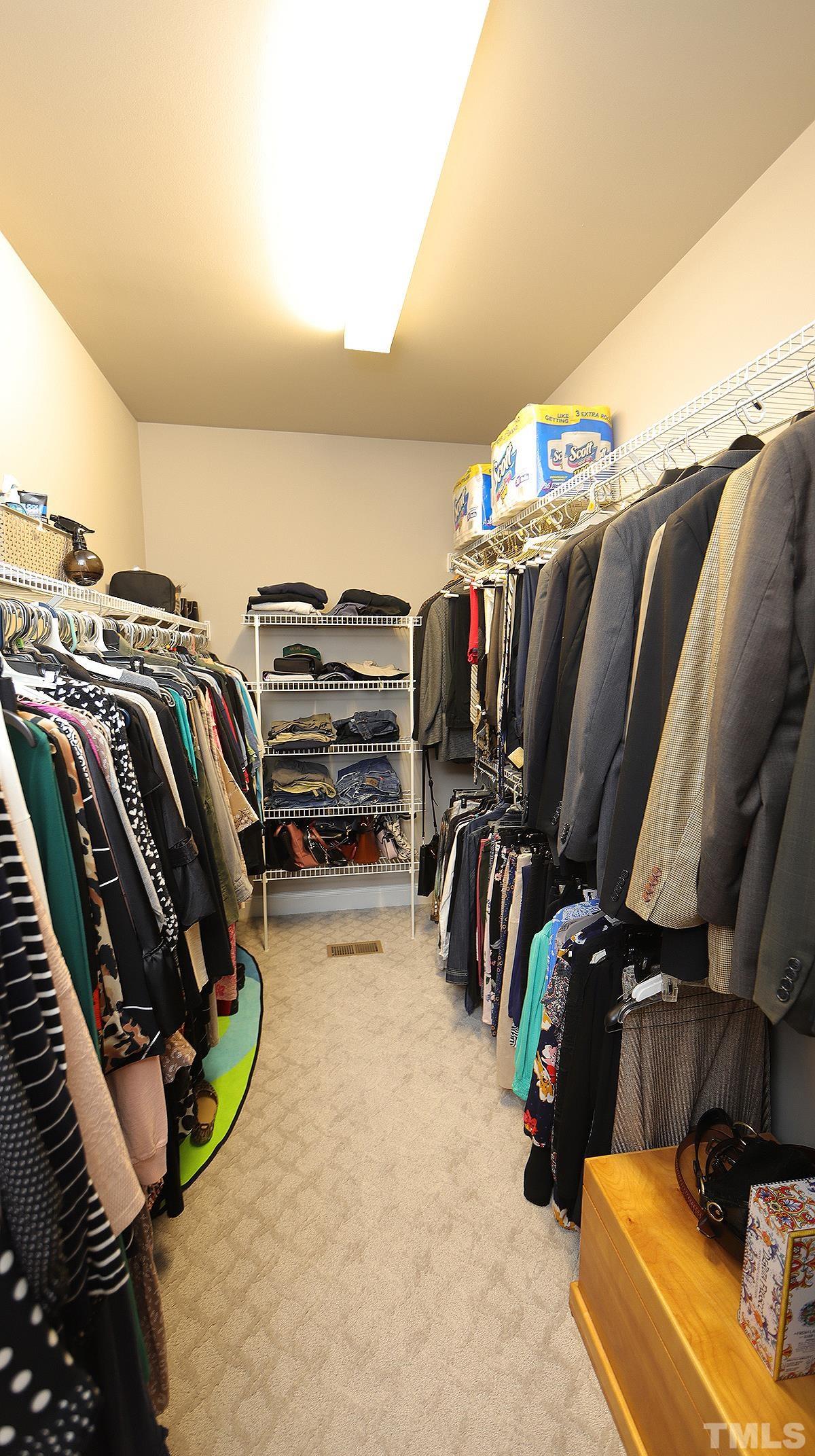 152 Rivers Edge Court Timberlake, NC 27583 - Photo 21 of 41 a view of walk in closet with clothes and shoes