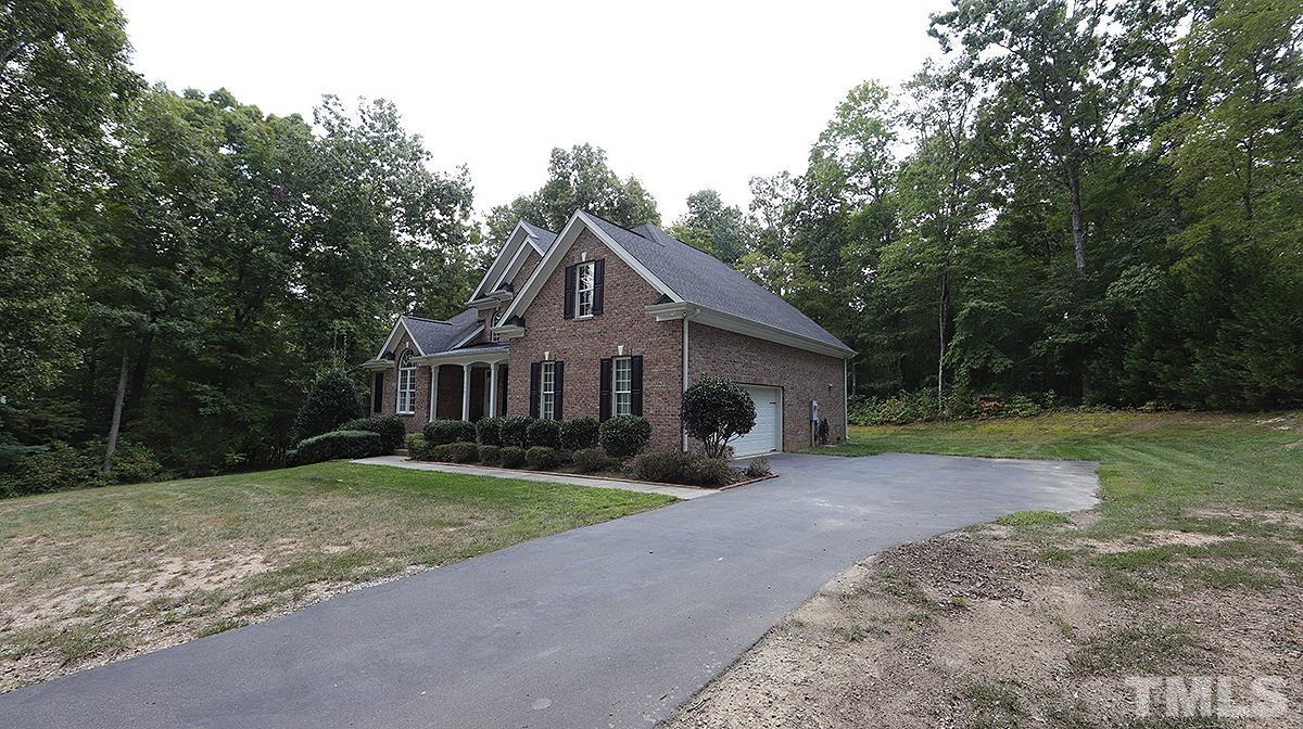152 Rivers Edge Court Timberlake, NC 27583 - Photo 3 of 41 a front view of a house with garden