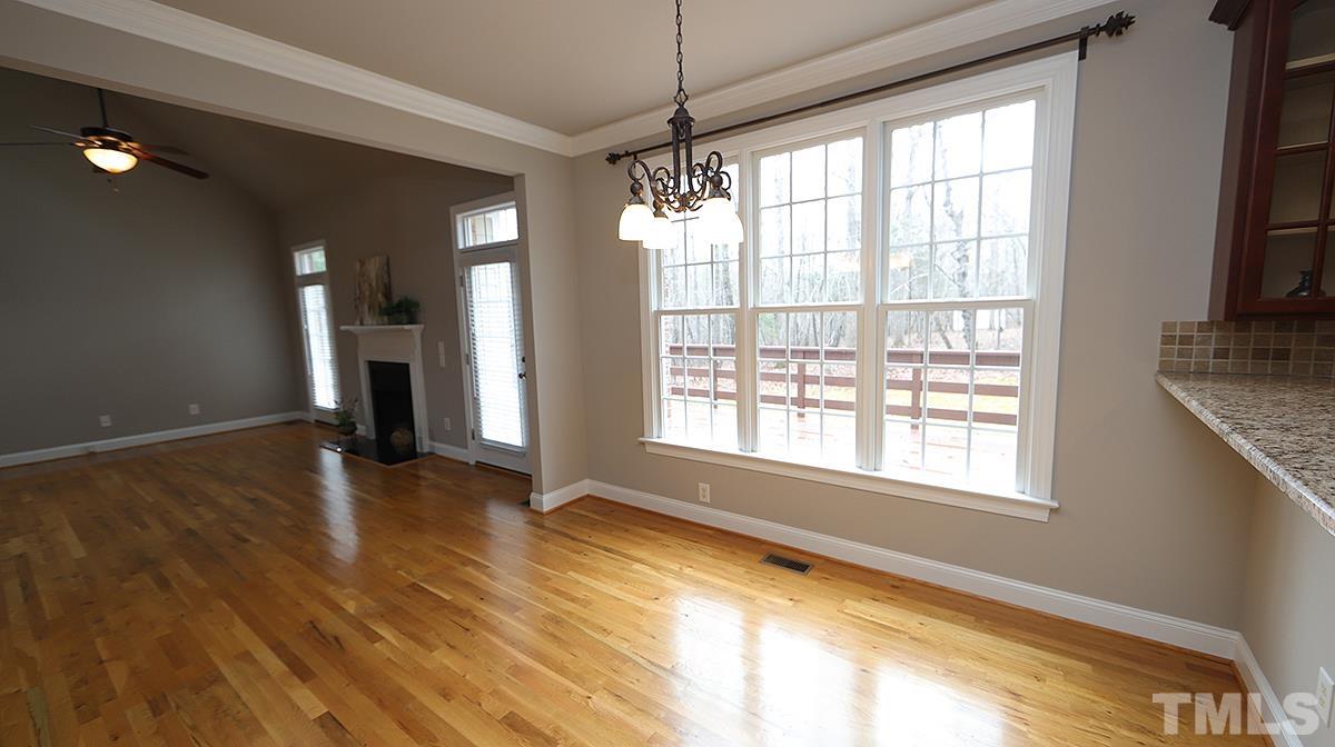 152 Rivers Edge Court Timberlake, NC 27583 - Photo 39 of 41 a view of an empty room with a window and wooden floor