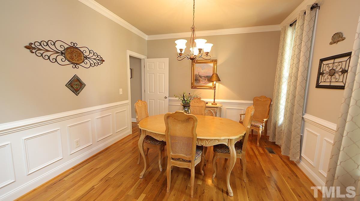 152 Rivers Edge Court Timberlake, NC 27583 - Photo 6 of 41 a view of a dining room with furniture and wooden floor