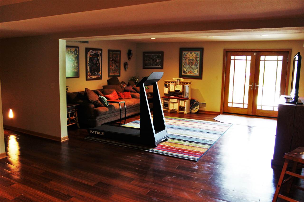 766 Timber Ridge Trail Rockford, IL 61114 - Photo 17 of 25 a living room filled with furniture and a wooden floor