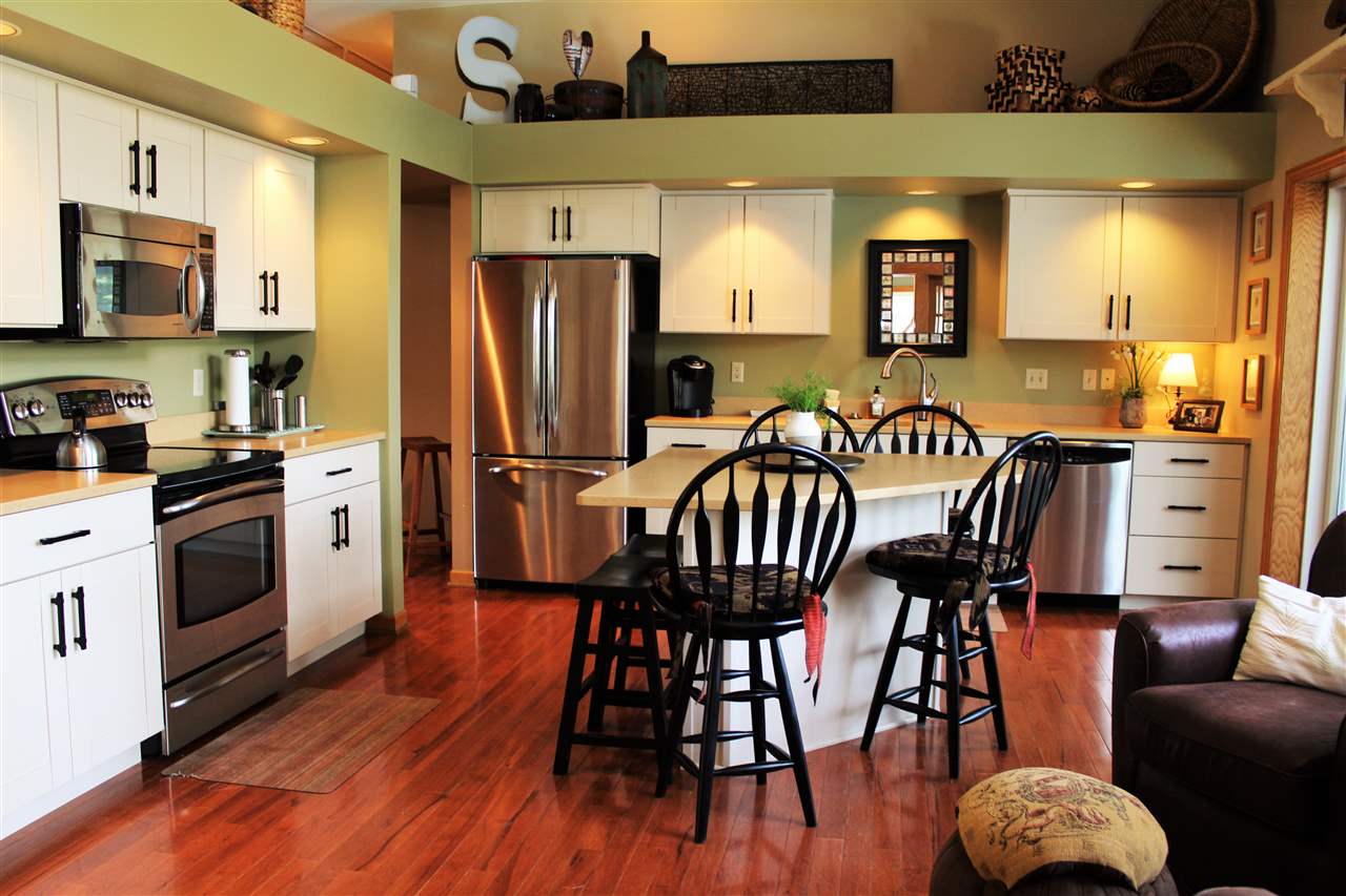 766 Timber Ridge Trail Rockford, IL 61114 - Photo 6 of 25 a kitchen with stainless steel appliances granite countertop a dining table chairs refrigerator and sink
