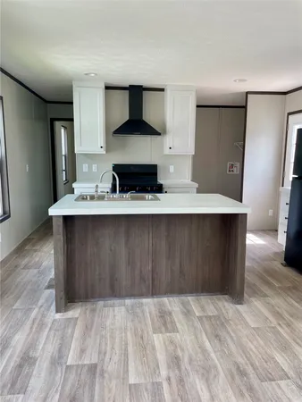 a view of kitchen with sink microwave and refrigerator